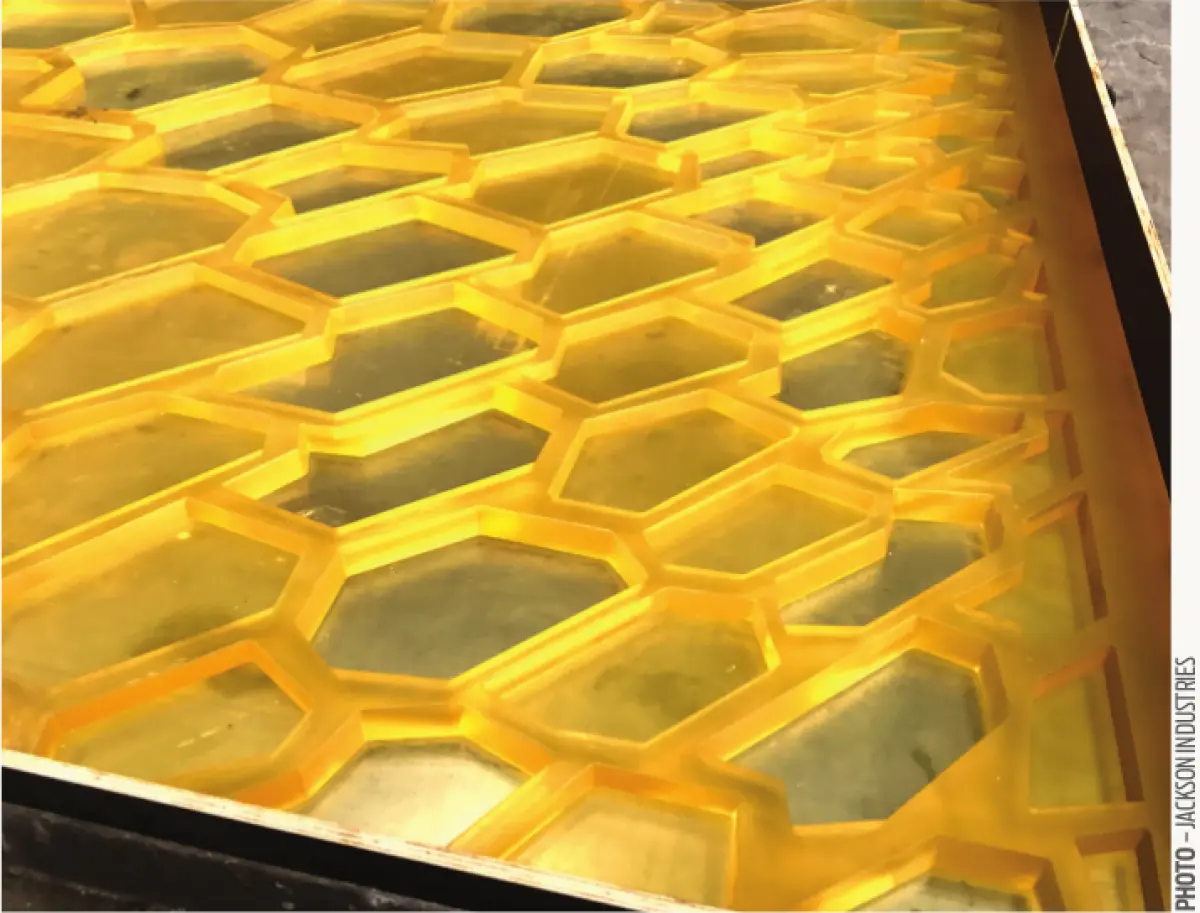 Photograph showing a yellow honeycomb‑patterned panel