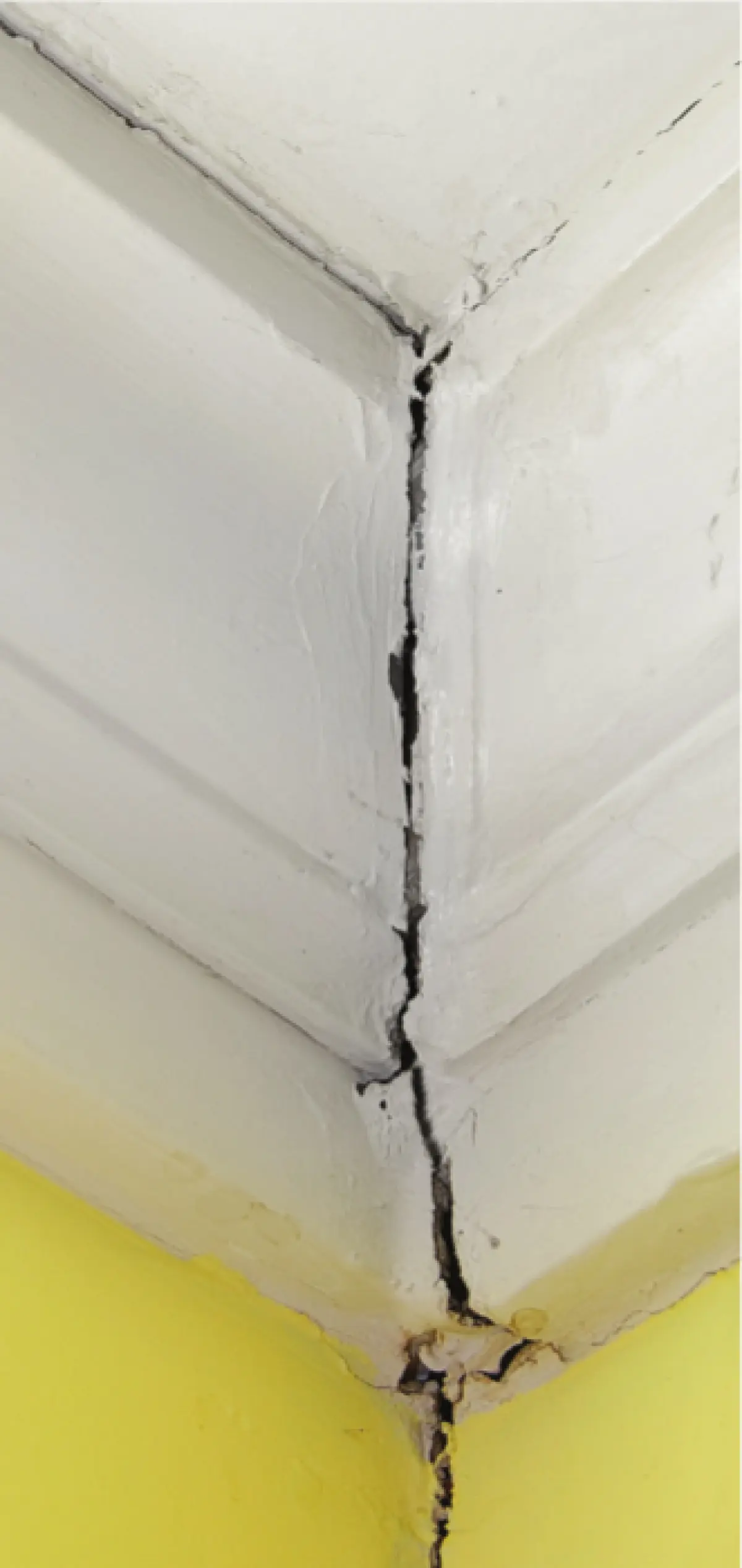 A close up photo of a damaged wall