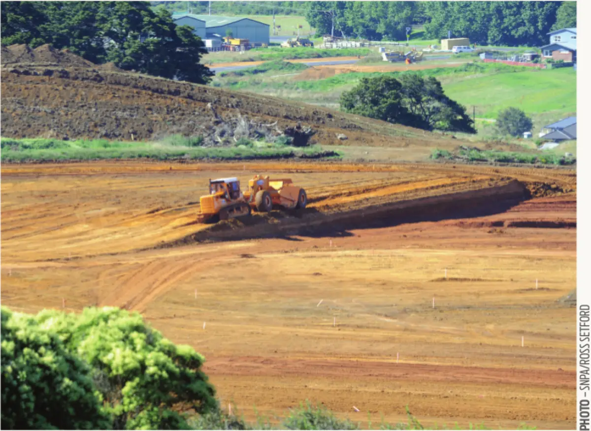 An image of a construction vehicle on a field of dirt