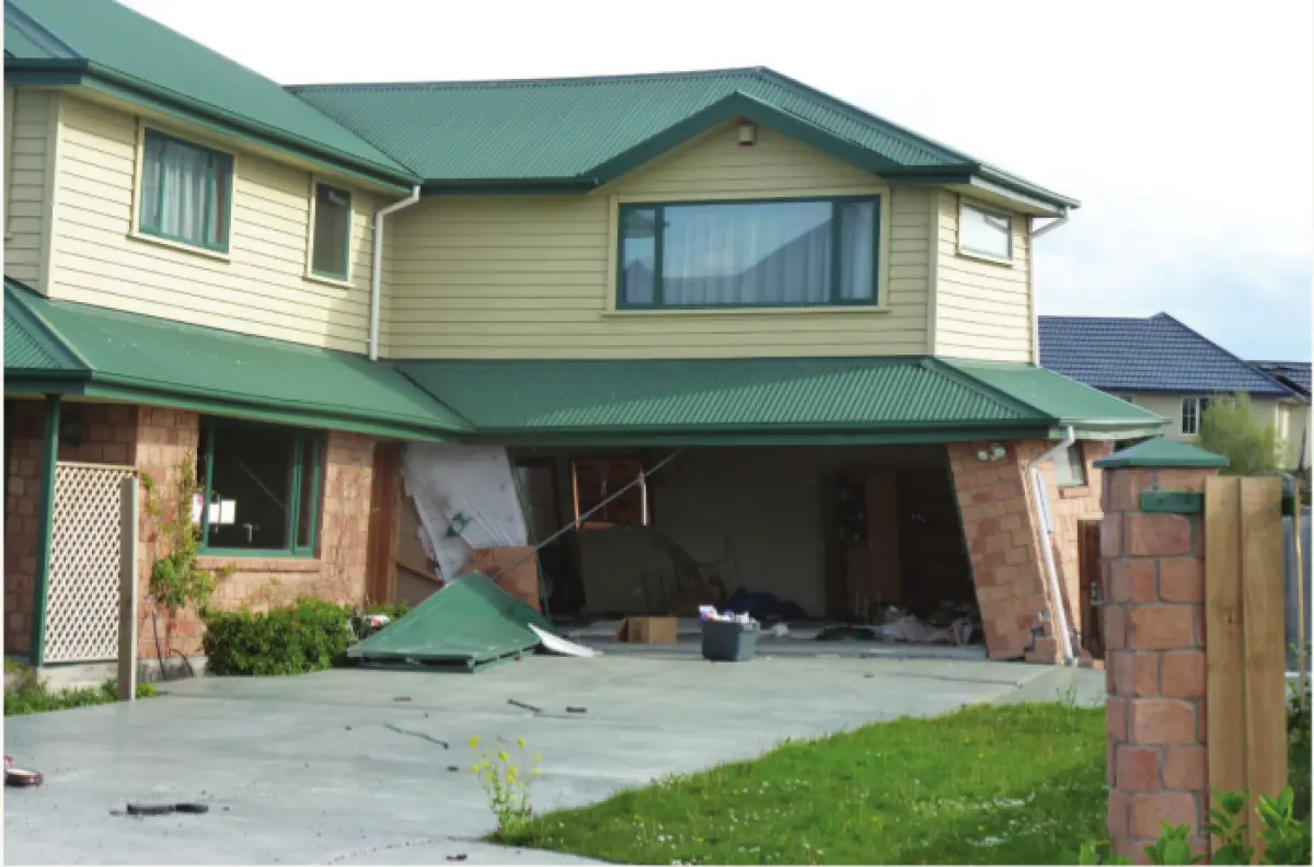An image of a two story house whose garage has collapsed