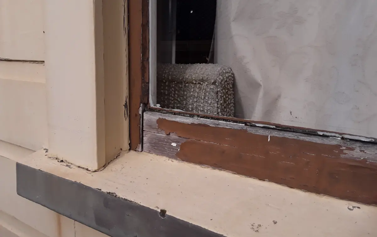 image of Peeling paint on a window sill