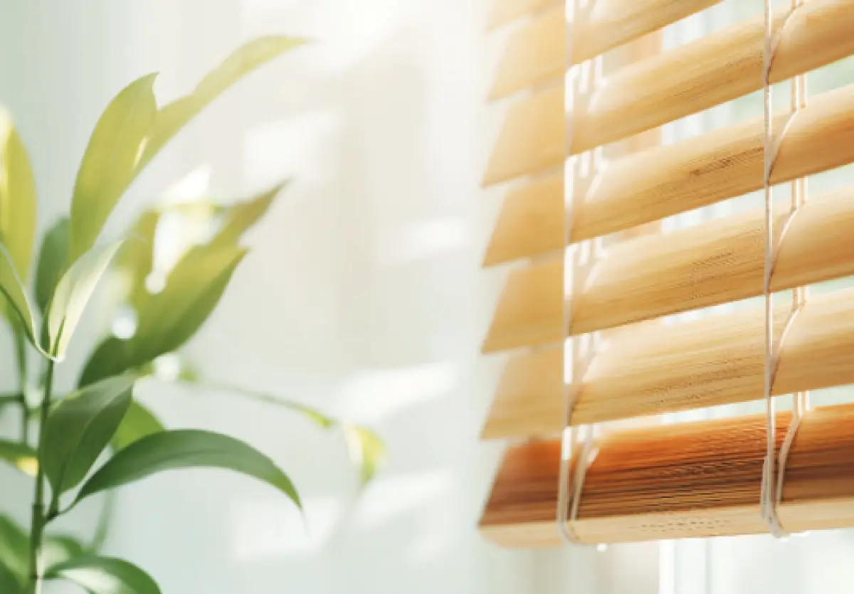 A photo of sun streaming through venetian blinds