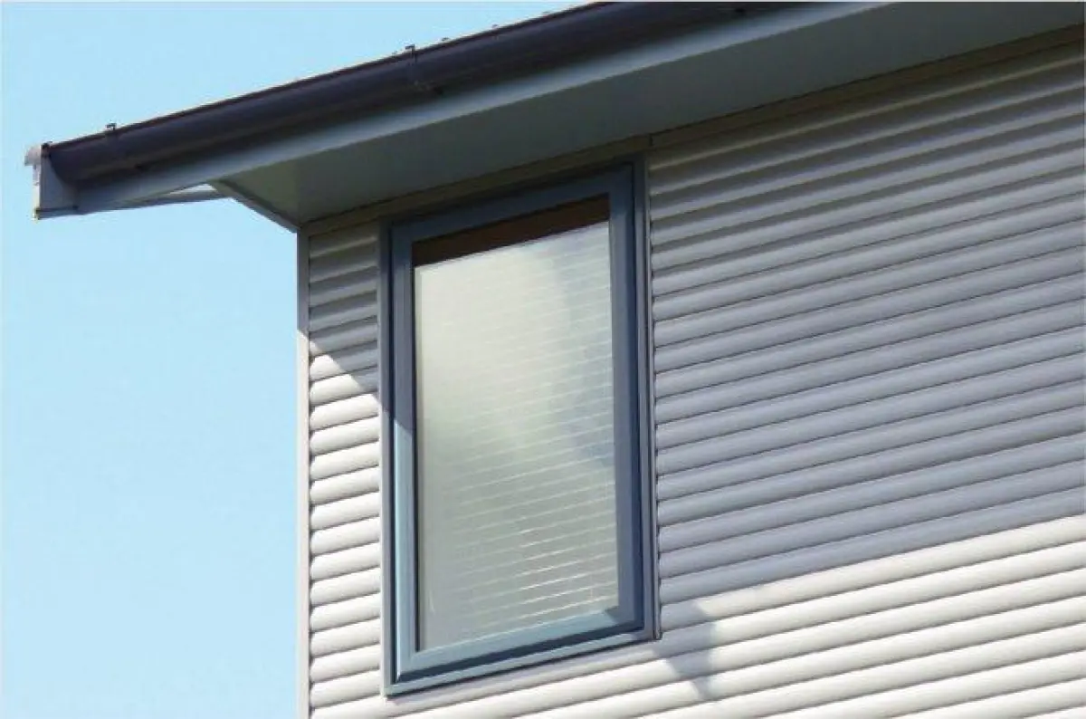 A photo of corrugated cladding with a roof overhang