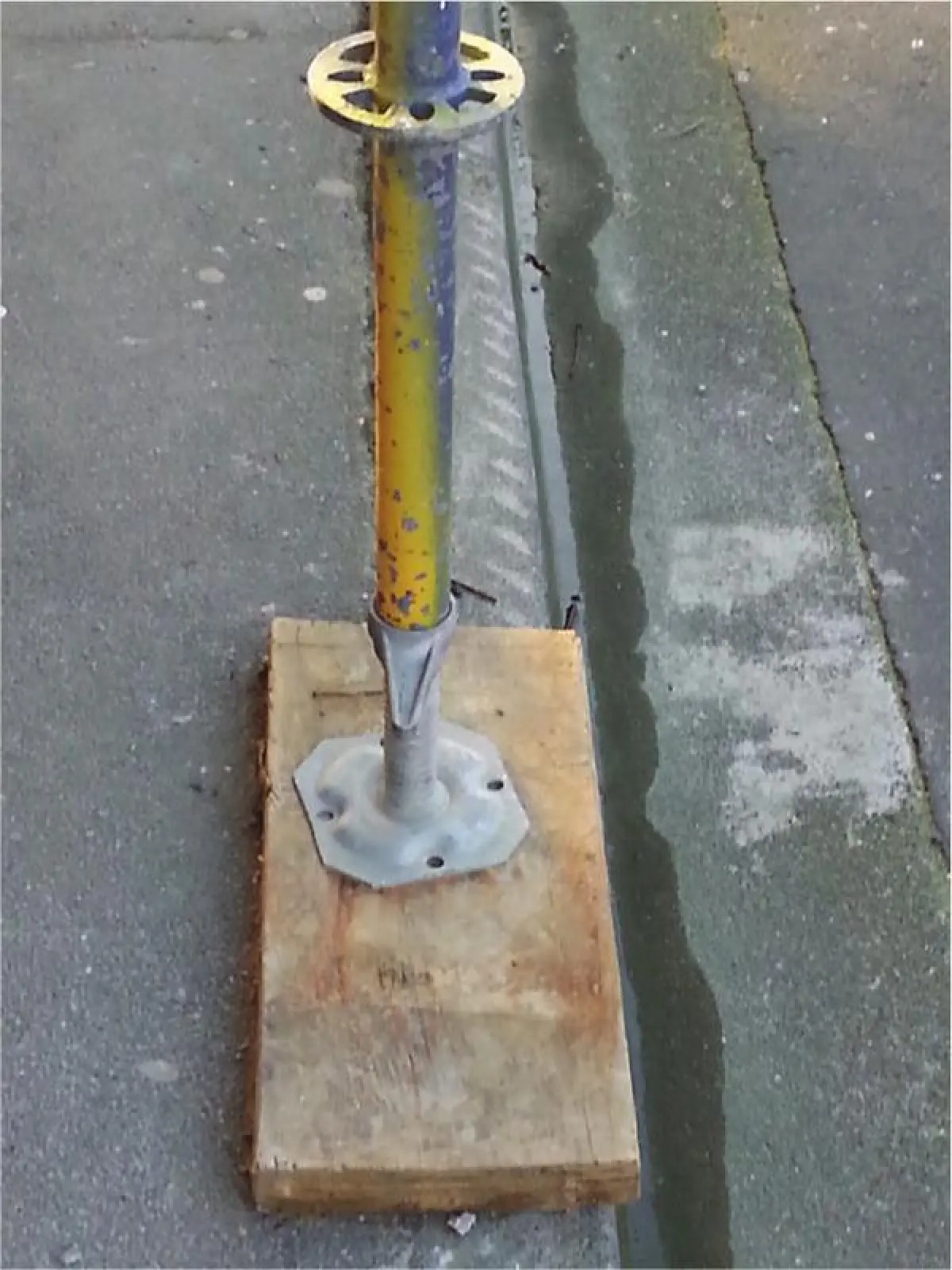 Image of a scaffolding leg on a wooden board