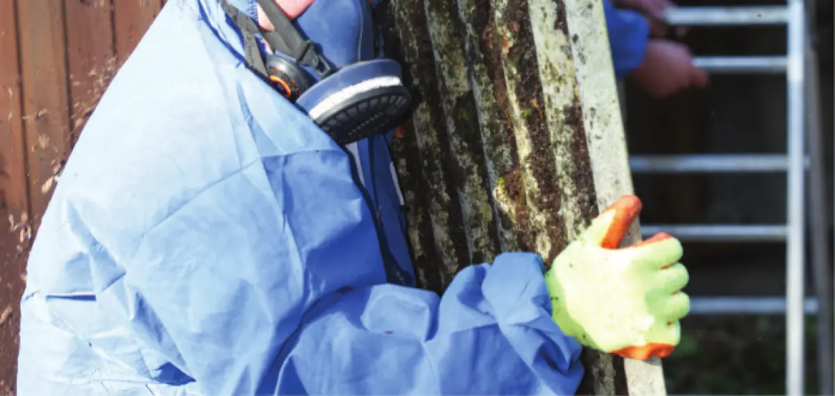 A man in a mask carrying asbestos