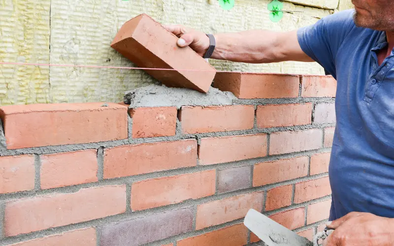 Weatherboards above brick veneer
